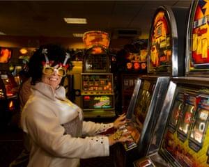 A female Elvis impersanotor hits the slot machines at an arcade in Porthcawl. Thousands of fans are expected to arrive in the town this weekend.